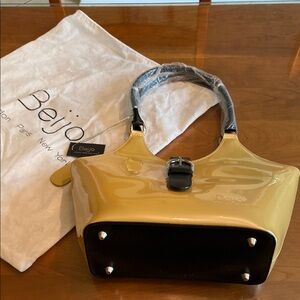 Super spacious Beijo gold patent  leather Tote with Black Trim. Brand new!!!!